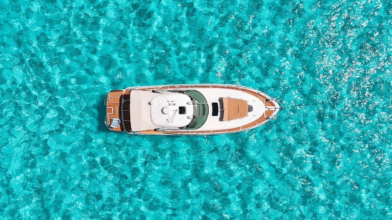 Aerial view of a private yacht in turquoise Caribbean waters